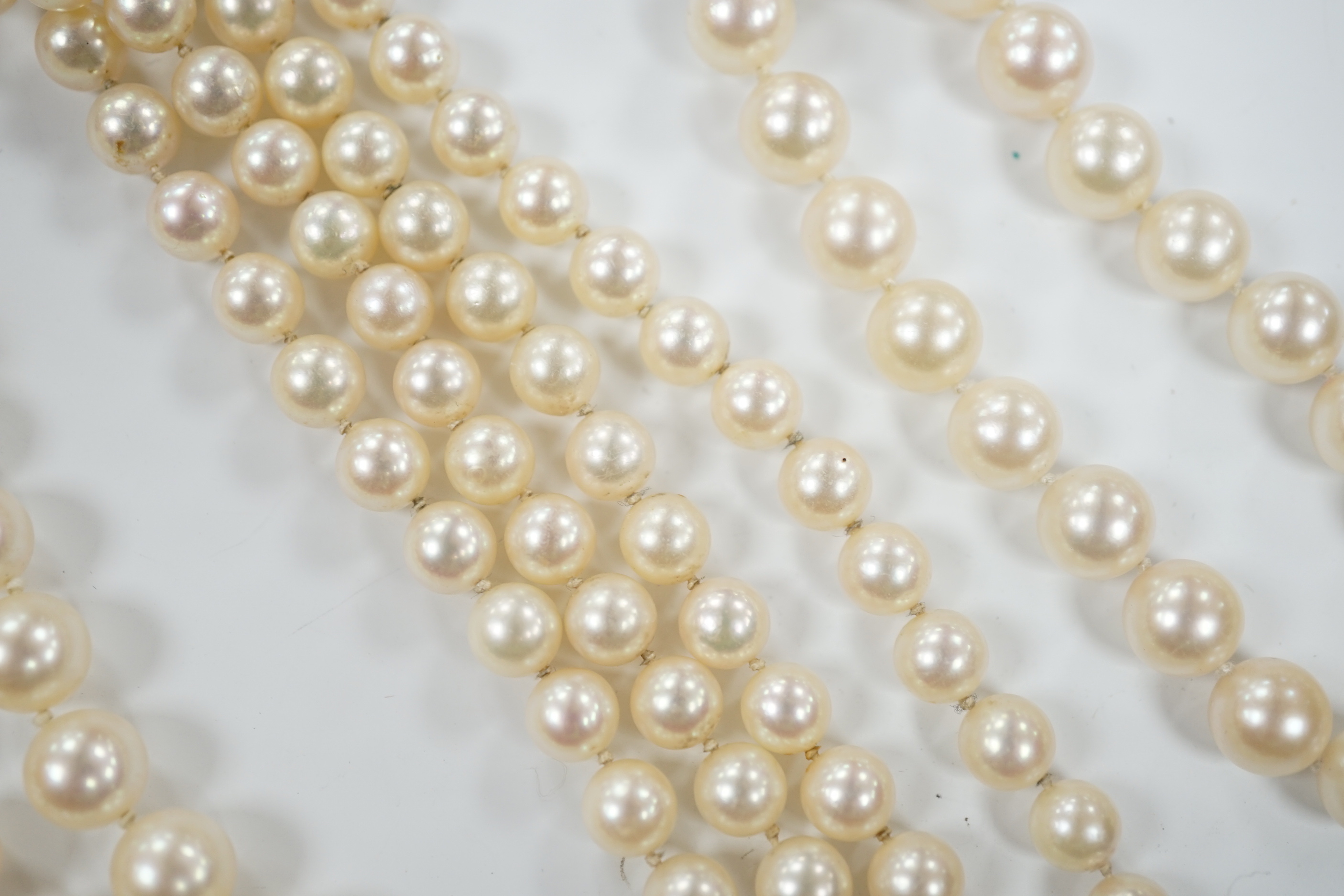 A single strand cultured pearl necklace, with diamond chip set 18ct gold clasp, 74cm and similar bracelet with diamond mounted clasps together with another cultured pearl necklace.